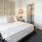 Bedroom with large bed, ensuite. queen bed and nightstands.