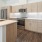 3 Bedroom Luxury Apartments In Old Town Scottsdale, AZ - Formation - White Quartz Countertops, Microwave, Stove, Light-Toned Wooden Cabinets, And Spacious Layout.