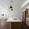 Spacious and well lit kitchen with wood flooring and stainless steel appliances
